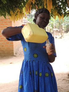 n Abia, Northern Uganda, farmer and grandmother Catherine Ekuka, 63, decants shea oil for cooking. Photo CWatson/ICRAF